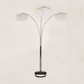 Arc floor lamp with three crystal-like shades on a beige background