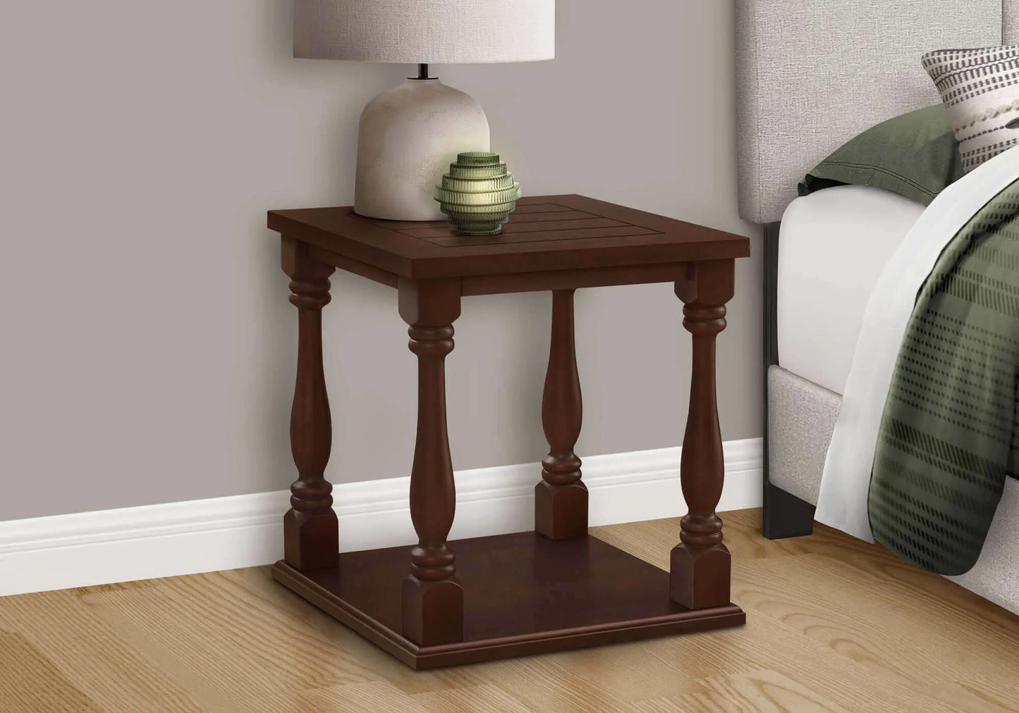 Wooden end table with decorative items in a bedroom setting