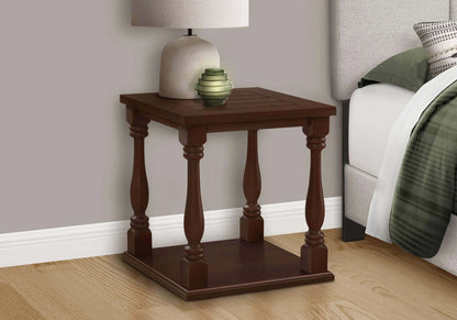 Wooden end table with decorative items in a bedroom setting