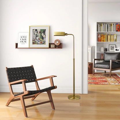 Modern living room with a wooden chair, brass floor lamp, and bookshelf.