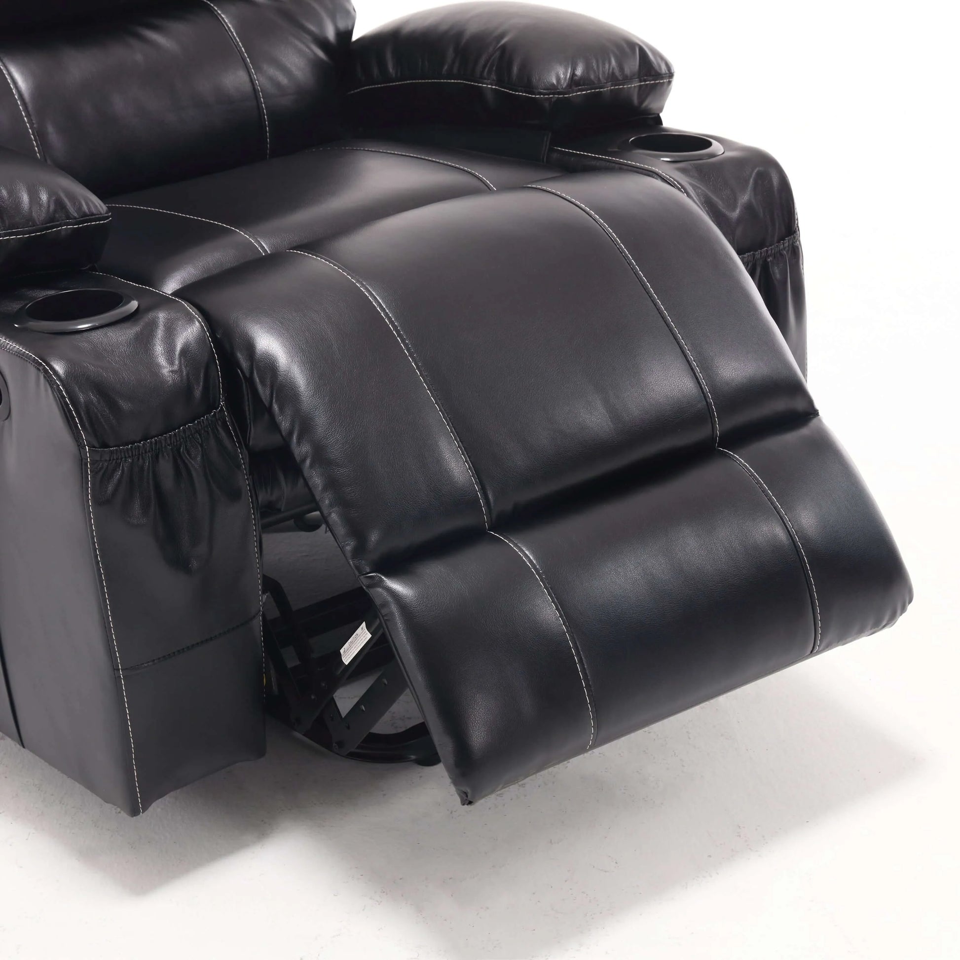 Close up of a black faux leather power lift recliner chair footrest with detailed stitching on a white background