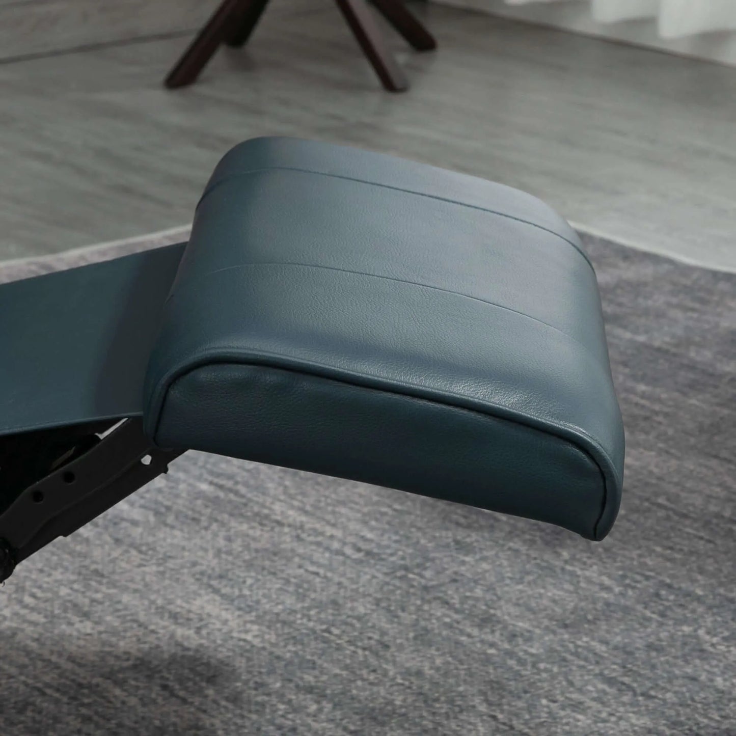Close up of a blue recliner chair footrest with a blurred background