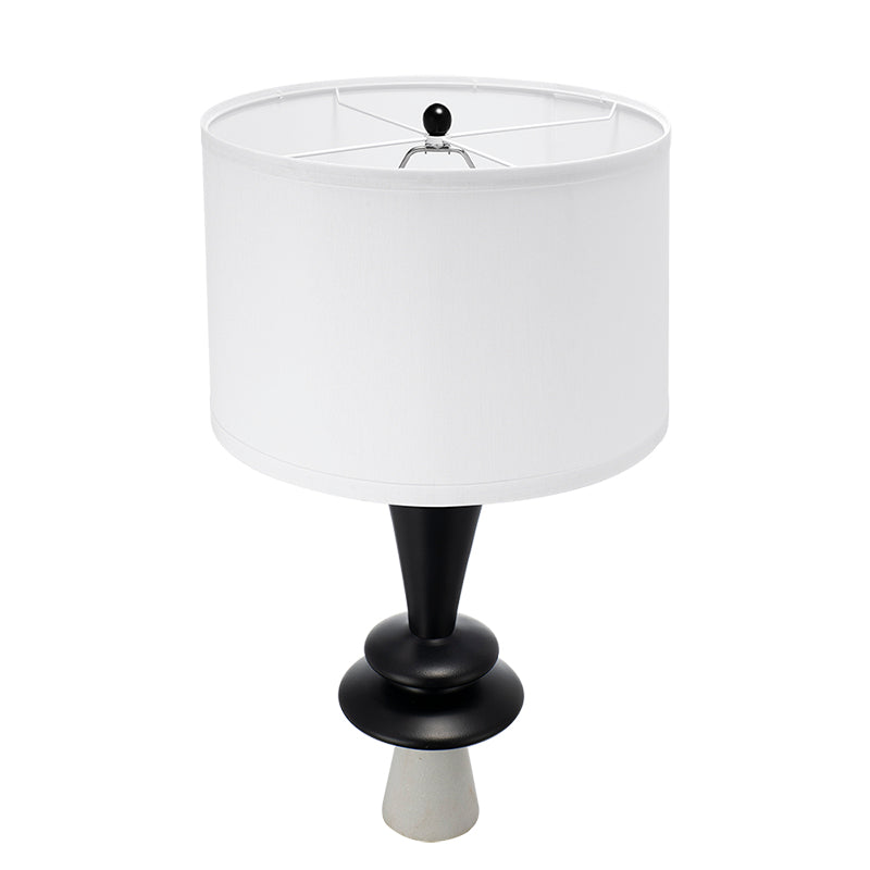 Table lamp with white shade and black base on a white background