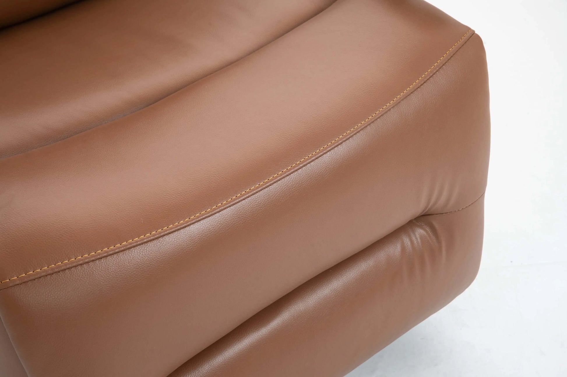 Close-up of a brown leather recliner chair footrest with visible stitching on a white background