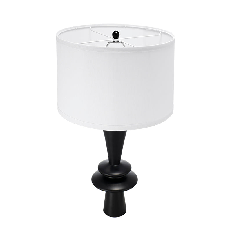 Table lamp with a white shade and black base on a white background