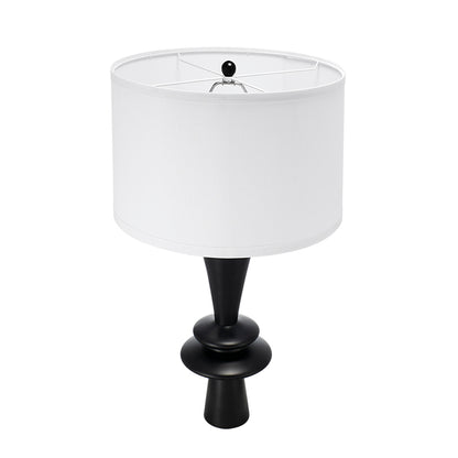 Table lamp with a white shade and black base on a white background