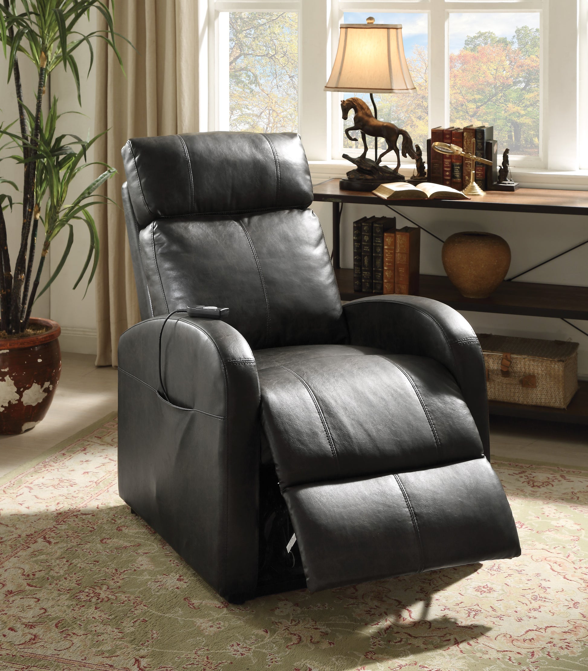 Dark brown leather recliner chair in a room with a desk and window