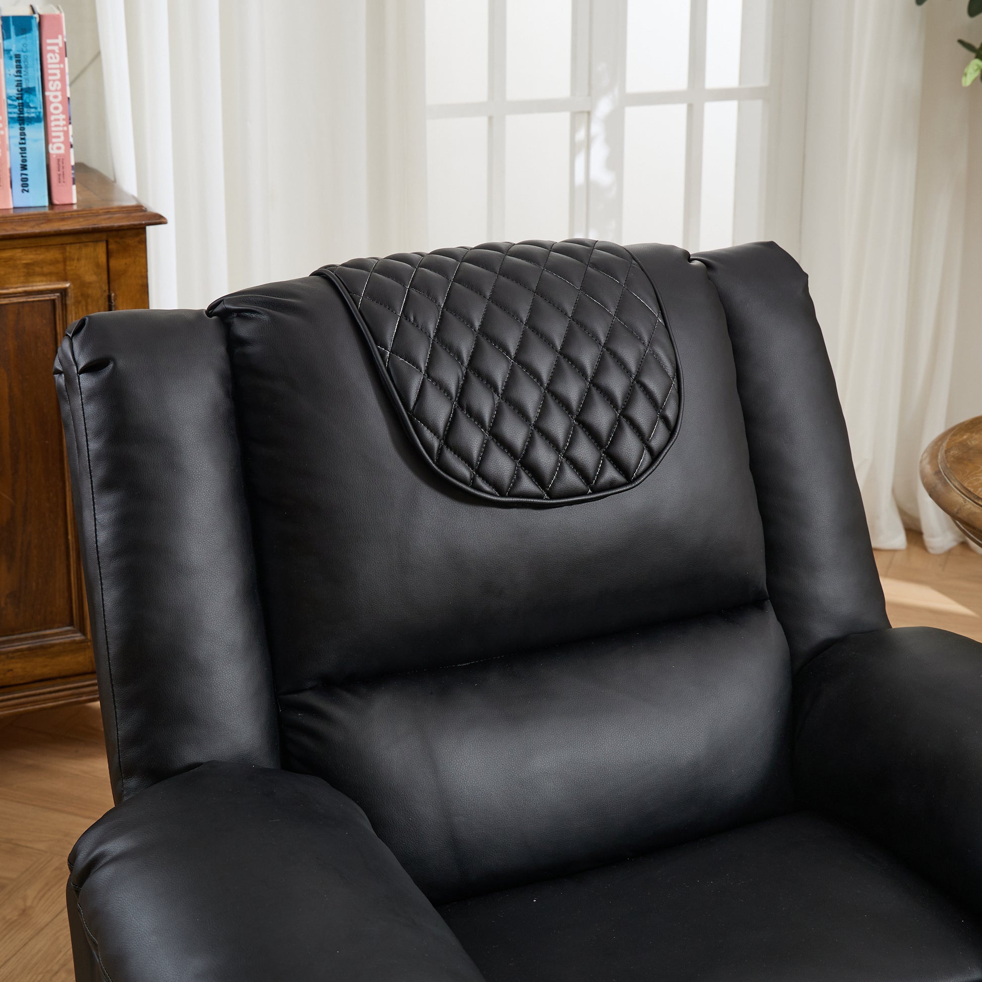 Black leather armchair with quilted backrest in a room setting