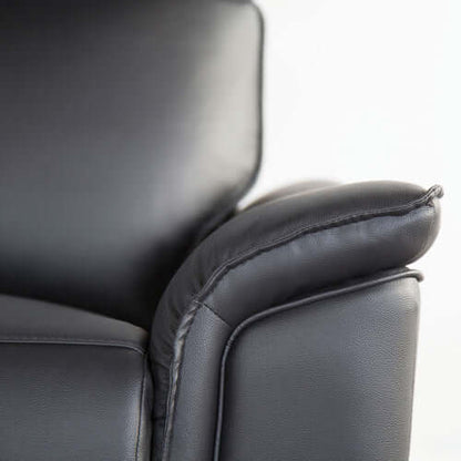 Close-up of a black leather recliner chair pillow arm top on a white background