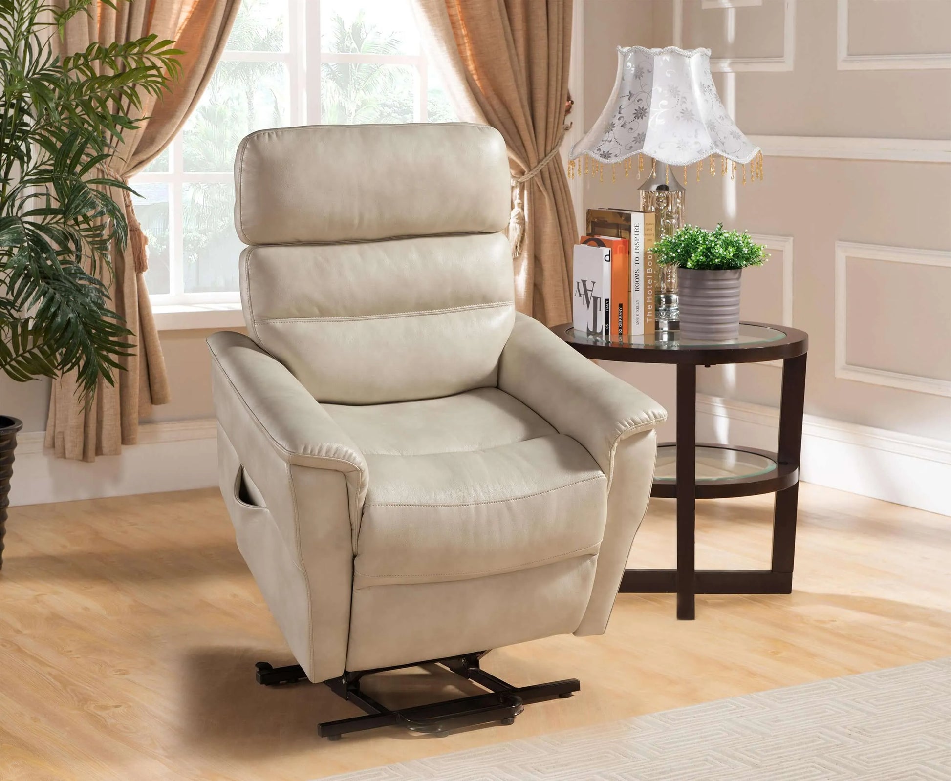 Cream color recliner chair in a living room setting with a side table and lamp.