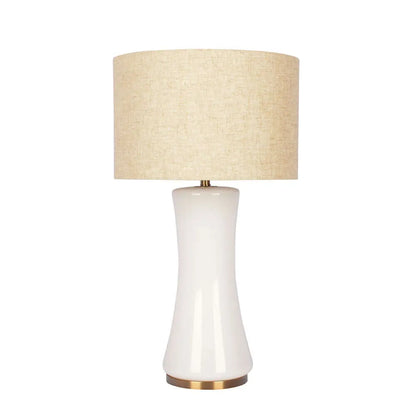 Table lamp with a beige lampshade and white base on a white background