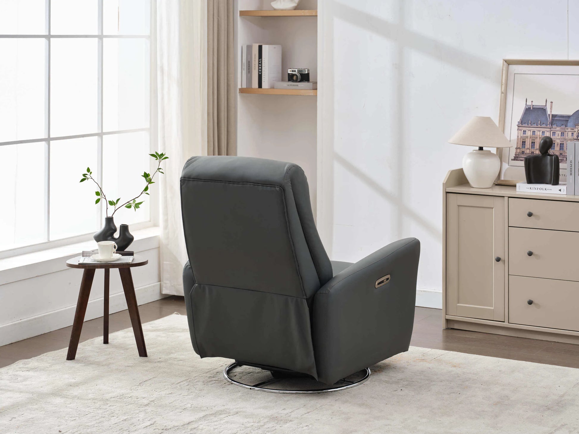 Power Swivel Glider Recliner-Dark Gray back view angled to show recliner chair controls in a small room