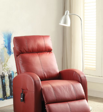 Red leather recliner chair in a room with a lamp and painting.