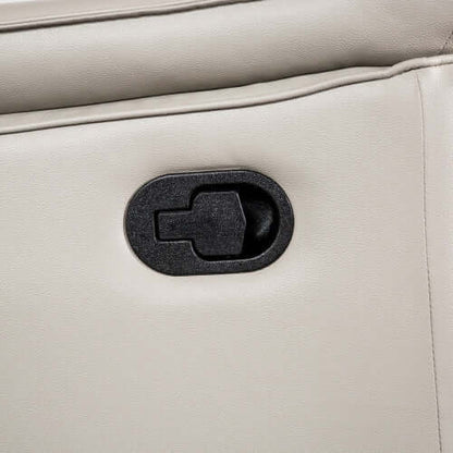 Close-up of a beige leather recliner chair with a black plastic pull tab.
