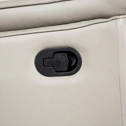 Close-up of a beige leather recliner chair with a black plastic pull tab.