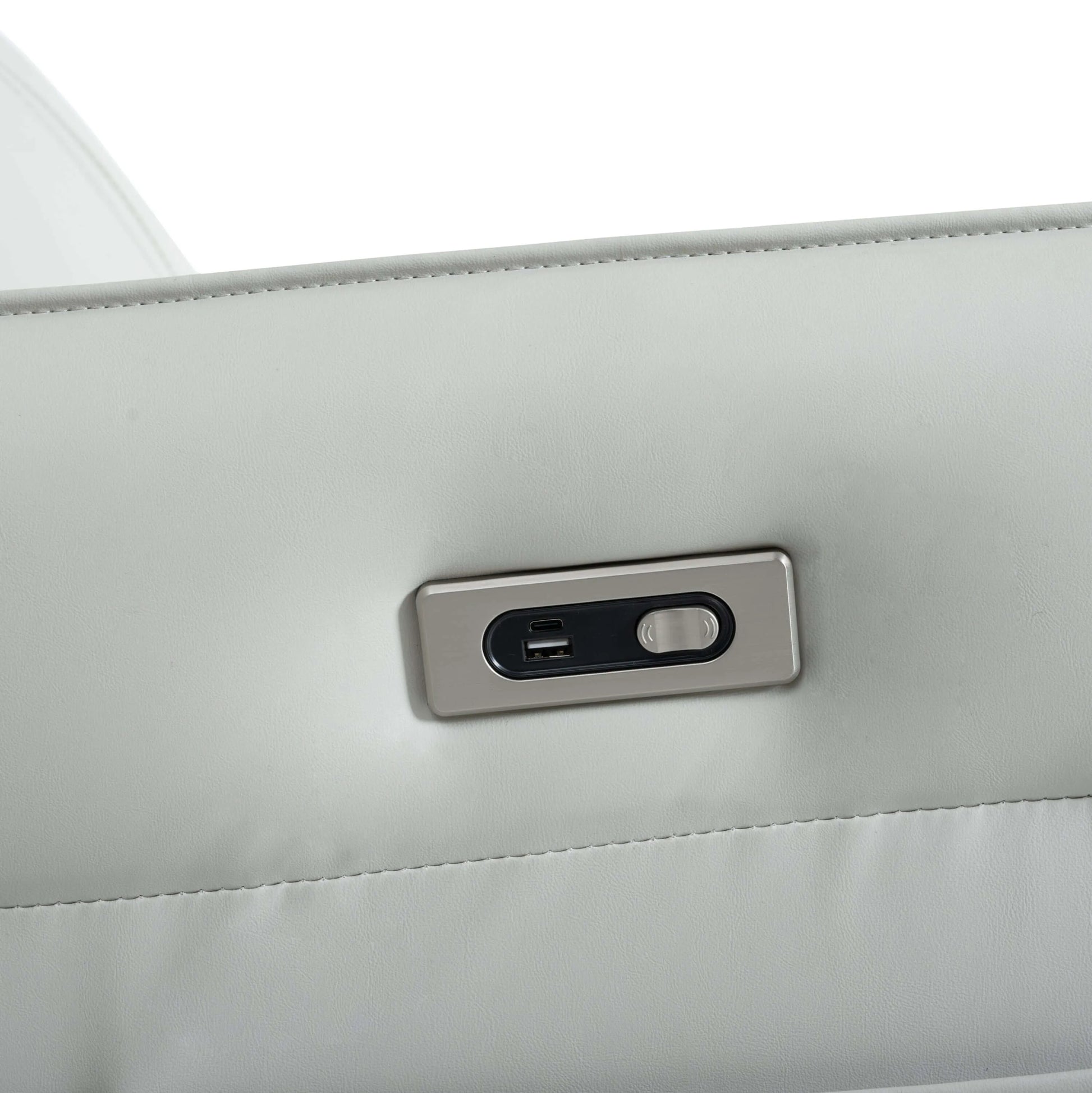 Close-up of a USB port and power button on a gray recliner chair