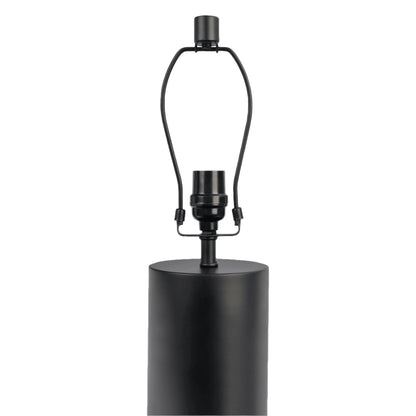 Black cylindrical table lamp base with wiring on a white background