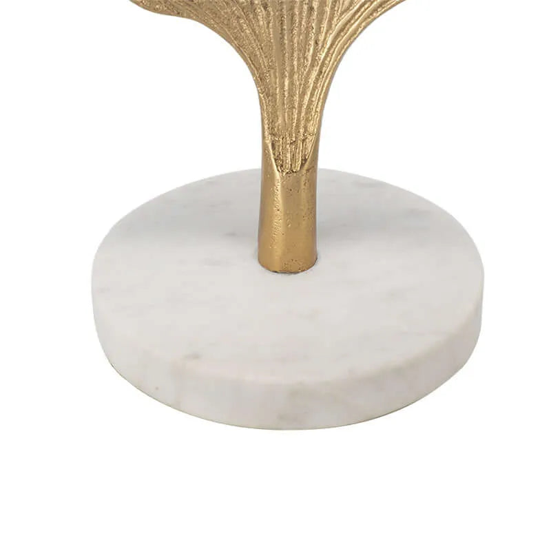 Close up of table lamp marble base with decorative gold stand on a white background.