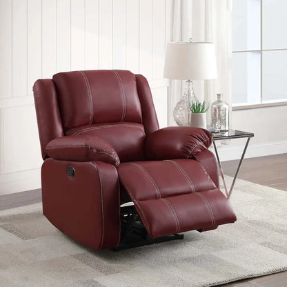 Red leather recliner chair partially reclined in a living room setting with a lamp and decor items.