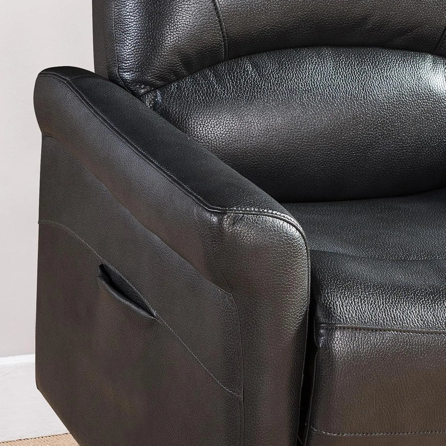 Close-up of a black faux leather recliner chair
