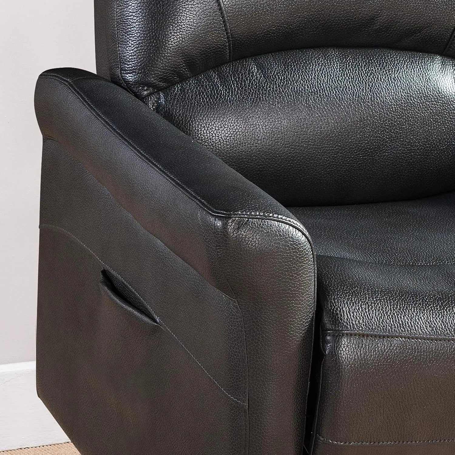 Close-up of a black faux leather recliner chair