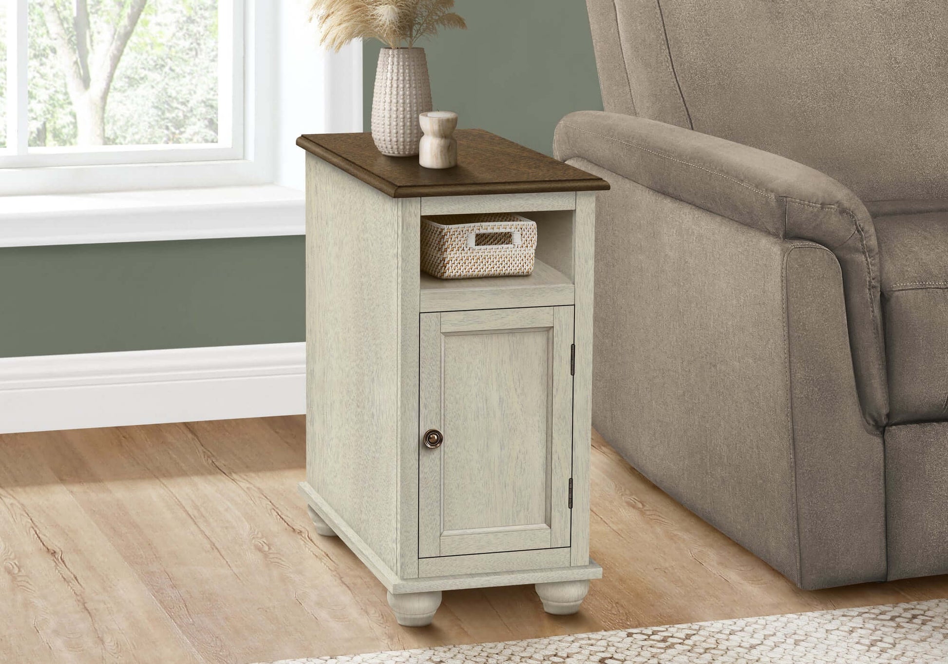 Small end table with a brown top next to a gray recliner in a living room.
