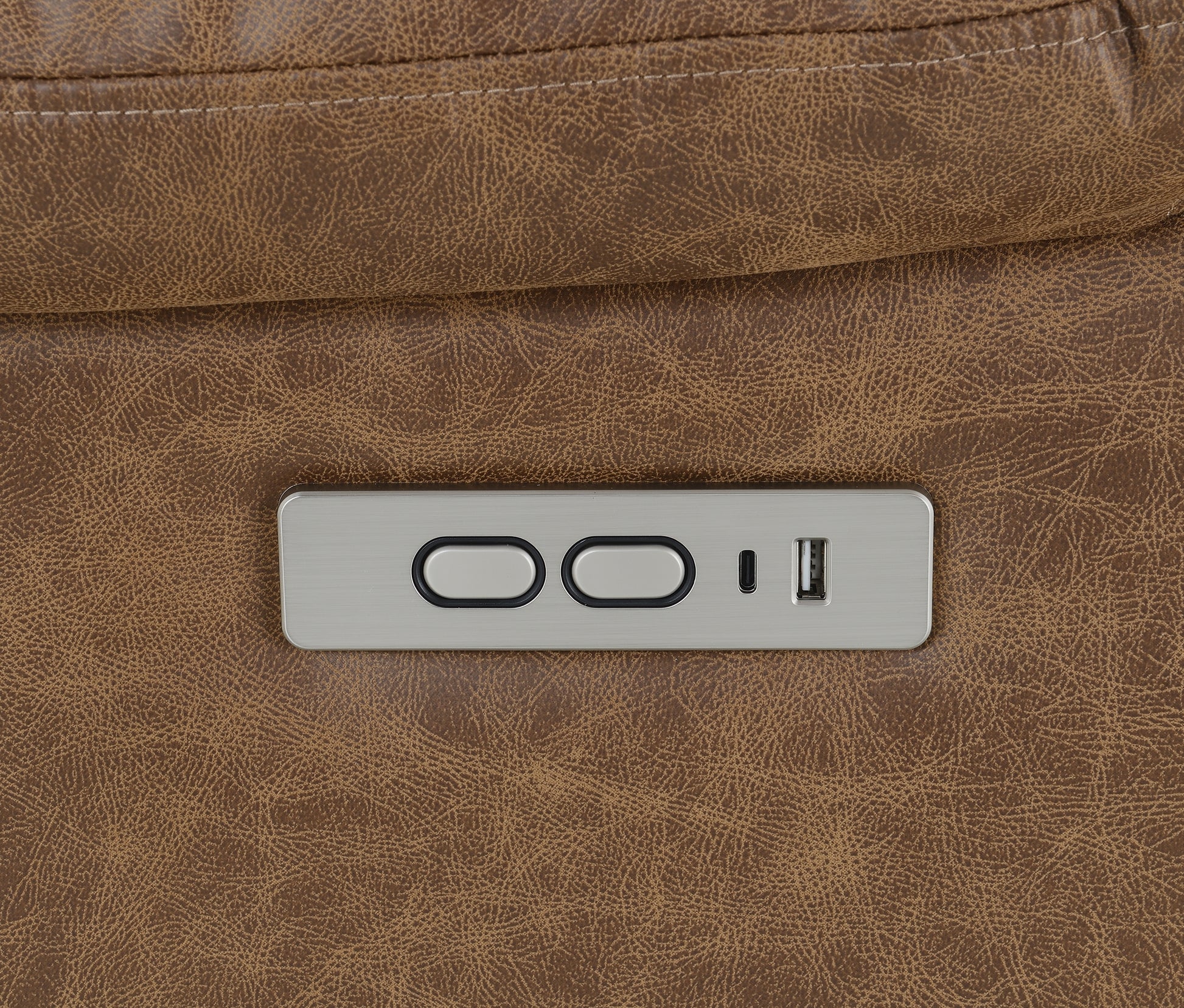 Close-up of a control panel on a brown leather recliner lift chair.