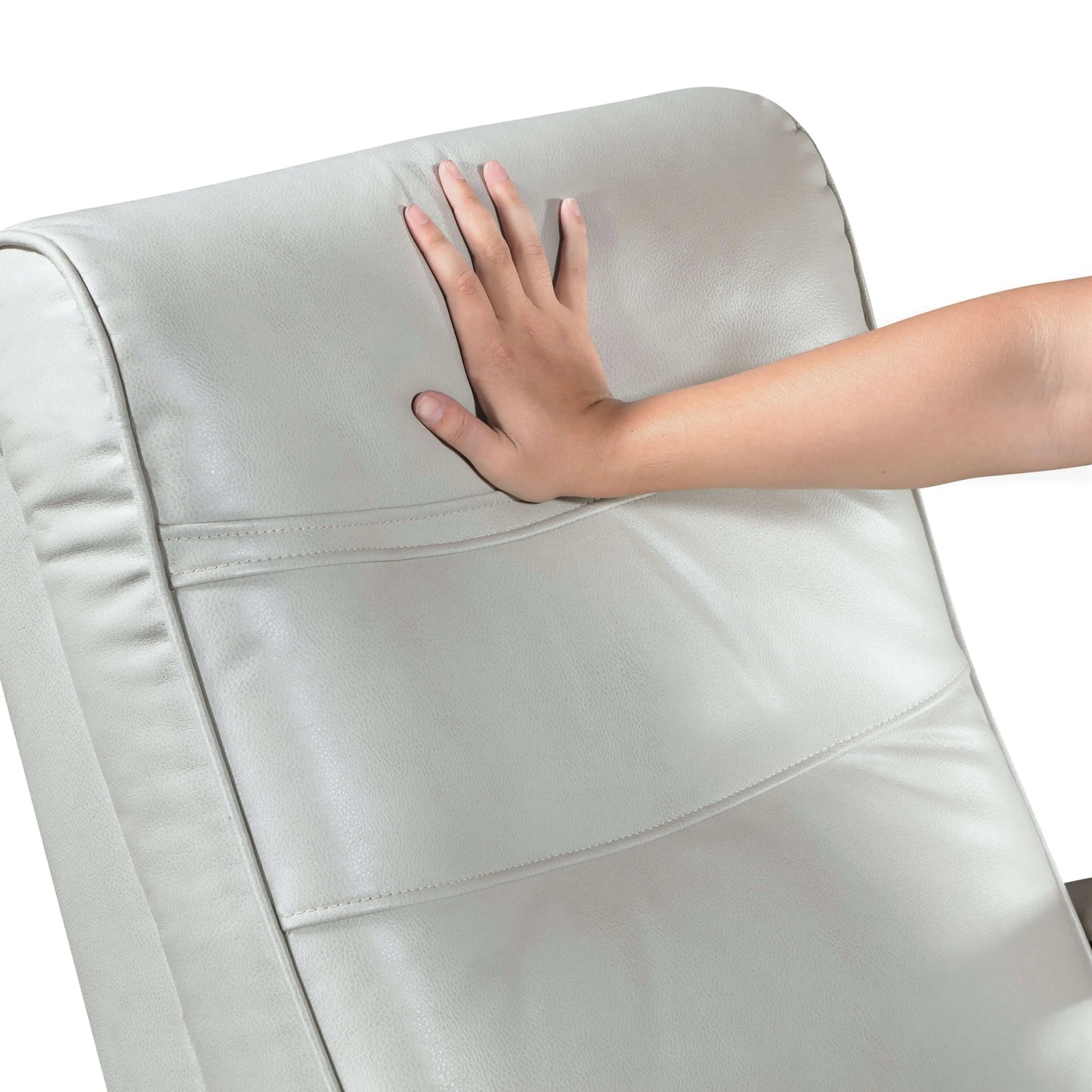 Hand touching a light gray leather recliner chair back cushion on a white background
