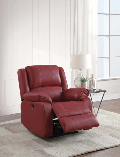 Red recliner chair in a living room setting with a lamp and decor items.