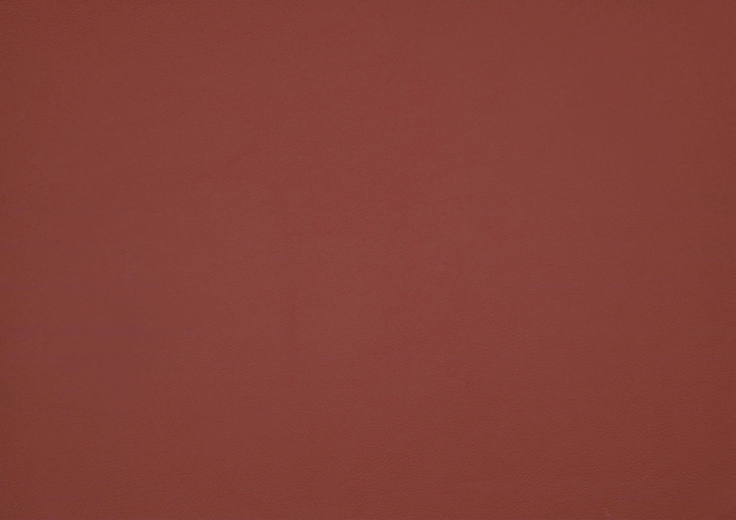 Solid red leather swatch with a textured pattern