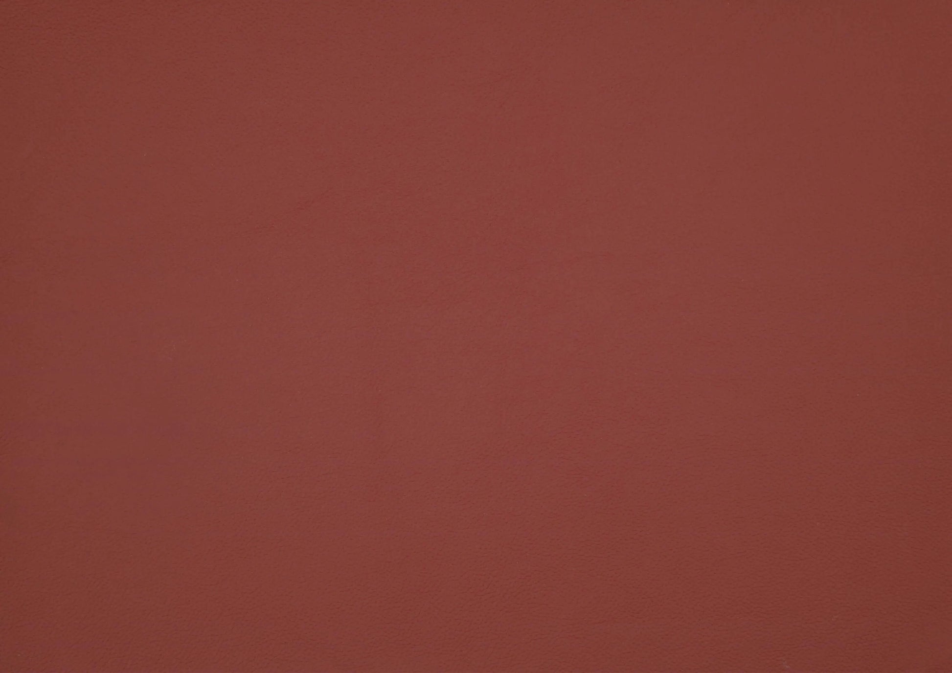 Solid red leather swatch with a textured pattern