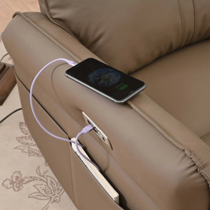 Smartphone charging on a brown leather recliner chair with a visible power cable.