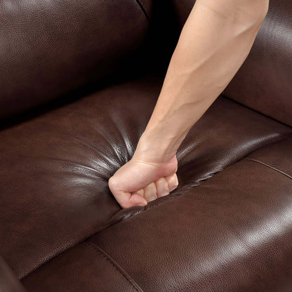 Person's fist on a brown leather recliner chair seat cushion.