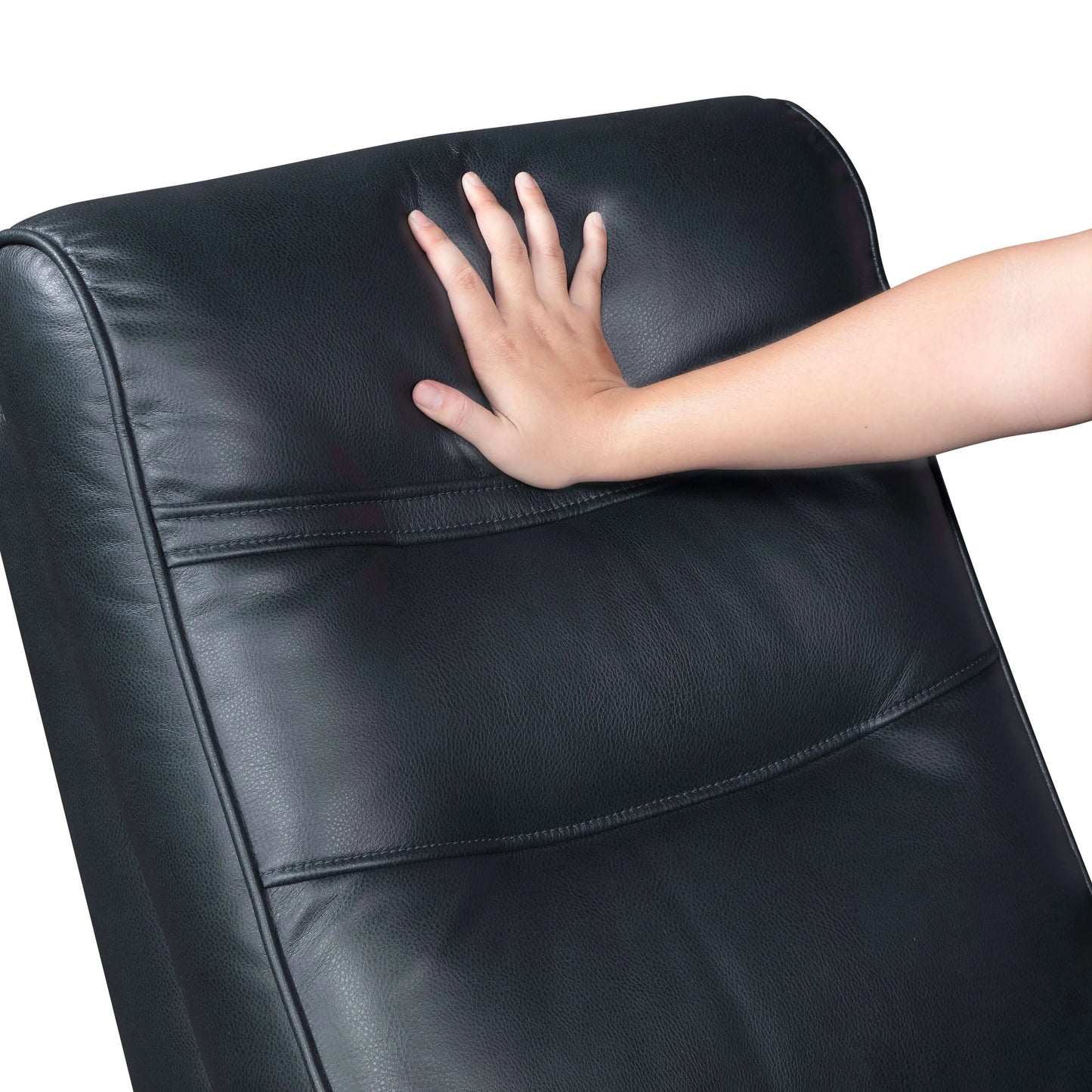 Hand touching top cushion of a navy blue faux leather recliner chair on a white background