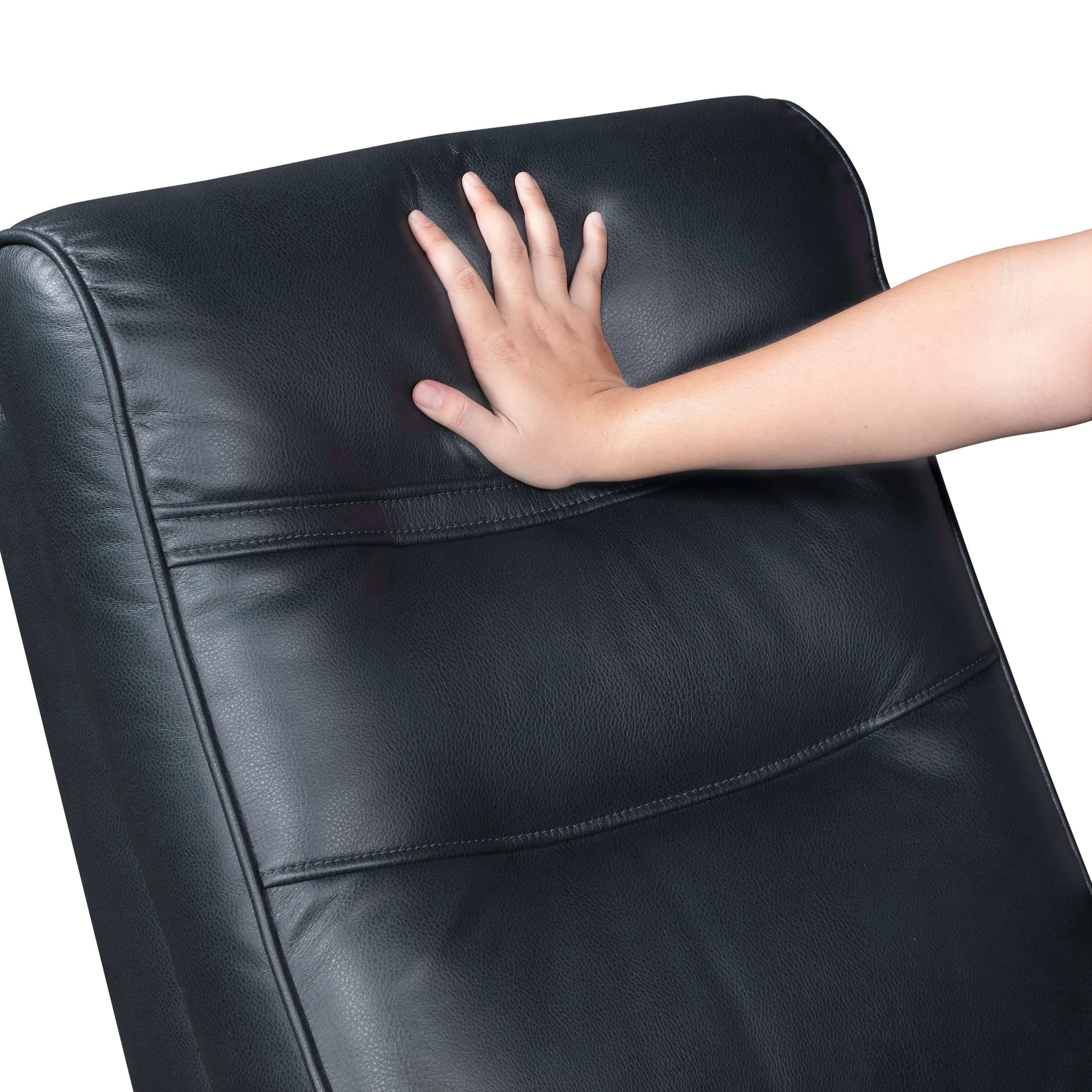 Hand touching top cushion of a navy blue faux leather recliner chair on a white background