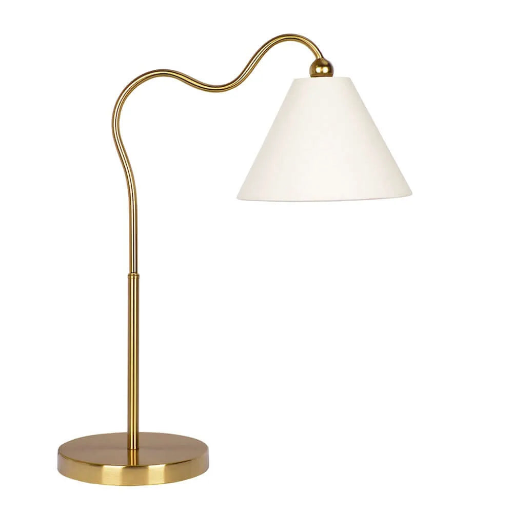 Gold table lamp with a white shade on a white background